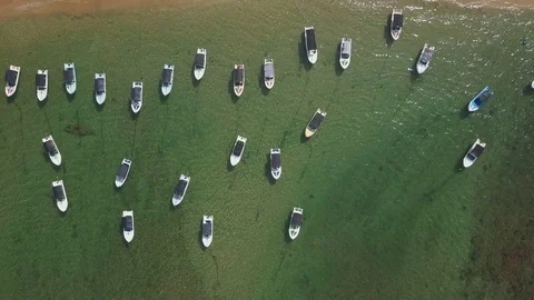 Top view beautiful beach line with boats in the ocean drone footage Stock Footage 84716572