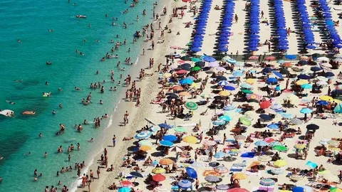 Top View Of A Beautiful Beach With Sunbathers in A summer Day In Tropea, Italy Stock Footage 77774904