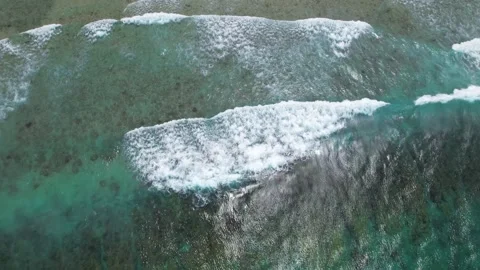 Top view of beautiful sand beach with azure seawater, wave passes, aerial shot Stock Footage 256152147