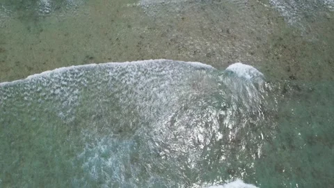 Top view of beautiful sand beach with azure seawater, wave passes, aerial shot Stock Footage 256219543