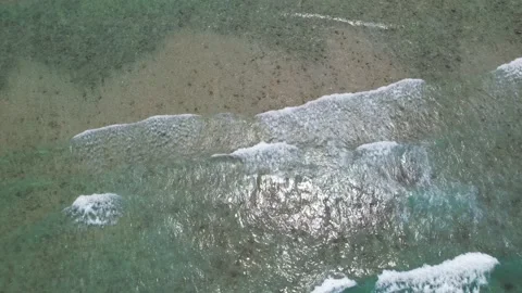 Top view of beautiful sand beach with azure seawater, wave passes, aerial shot Stock Footage 256456357