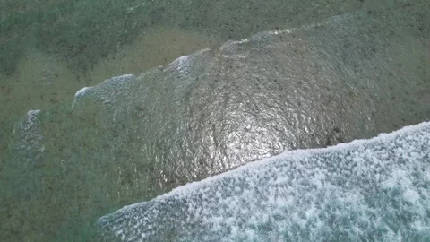 Top view of beautiful sand beach with azure seawater, wave passes, aerial shot Stock Footage 260196461