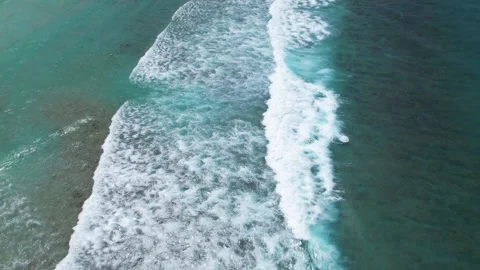 Top view of beautiful sand beach with azure seawater, wave passes, aerial shot Stock Footage 260196550