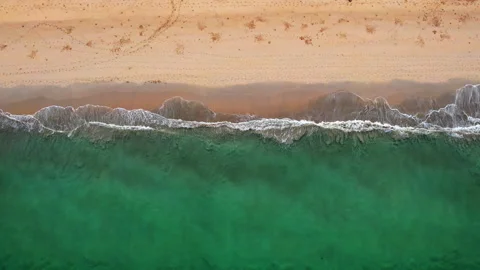 Top view of beautiful sand beach with emerald waves and golden sand, aerial shot Stock Footage 294729137