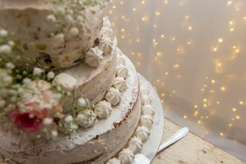 Top view. Beautiful white tree tier cake with fresh flowers with fairly light Stock Photos