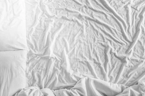 Top view bed with crumpled bed sheet, a blanket and pillows after comfort duvet Stock Photos