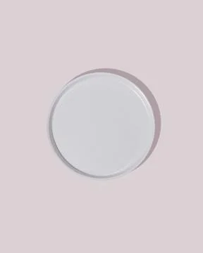 Top view of beige empty plate on pink background. Stock Photos