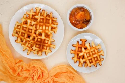 Top view of Belgian waffles on beige table. Stock Photos