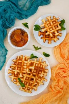 Top view of Belgian waffles on beige table. Stock Photos