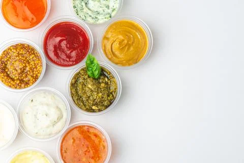 Top view on big assortment of different sauces on white background Stock Photos