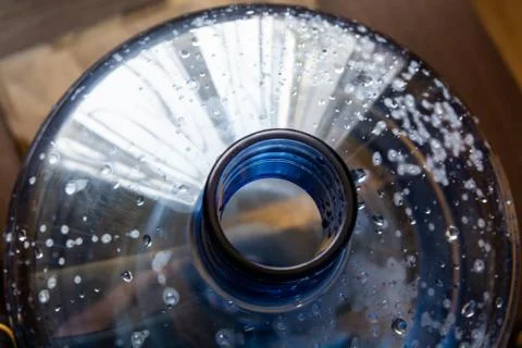 Top view on the big plastic bottle. Empty bottle for water cooler. Drops is o Stock Photos