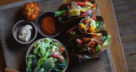 Top view of big tray of three raw vegan tacos with sour cream, broccoli Stock Footage 282971319