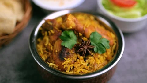 Top view of Biriyani. Indian chef cooking Biriyani at the kitchen and addin.. Stock Footage 337562690