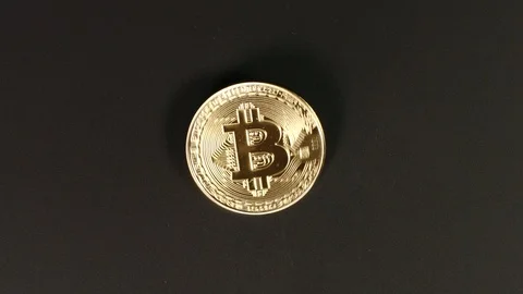 TOP VIEW: Bitcoin twists on a black table Stock Footage 88949092
