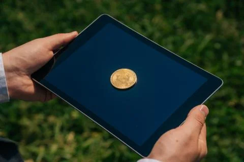 Top view of bitcon cryptocurrency lies on digital tablet. Virtual money or co Stock Photos