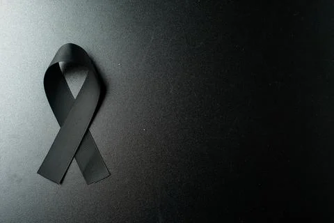 Top view of black bow as a mourning symbol on dark background death evil wa.. Stock Photos