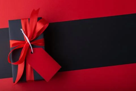 Top view of black boxes with red ribbon on black background and red backgroun Stock Photos