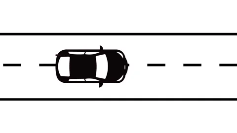 Top view of a black car driving on a straight road with dashed lines on whi.. 库存影片 325986987