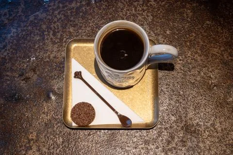 Top View of Black Coffee in Ceramic Cup With Cookie and Spoon on Gold Tray Stock Photos