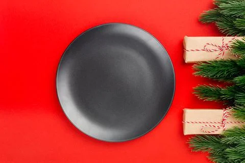 Top view of black empty plate with copy space on red isolated background with Stock Photos
