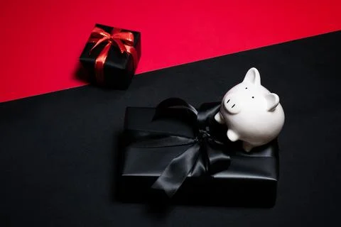 Top view of black gift box with red and black ribbons isolated on black bac.. Фото