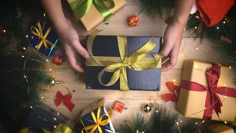 Top View of Black Gold Present Between Christmas Ornament on Wooden Texture Stock Footage 96152185