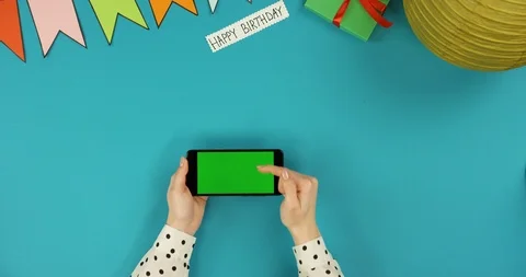 Top view on the black horizontal smartphone lying on the blue table with Happy Stock Footage 89313285