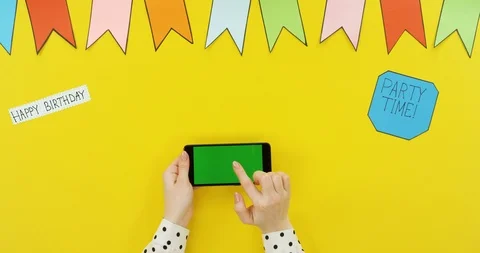 Top view on the black horizontal smartphone on the yellow table with decorations Stock Footage 89331154