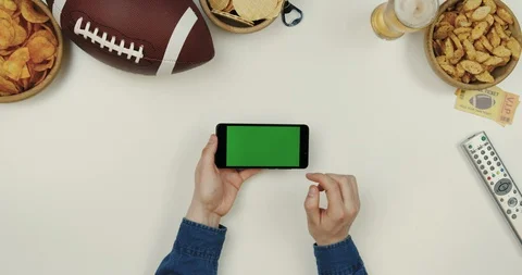 Top view on the black horizontal smartphone device on the white desk with rugby Stock-Footage 96325378