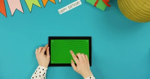 Top view on the black horizontal tablet device lying on the blue table with Stock Footage 89312557