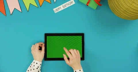 Top view on the black horizontal tablet device lying on the blue table with Video stock 89312718