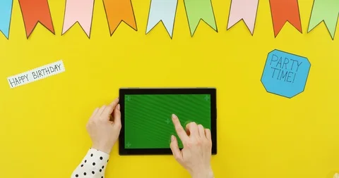 Top view on the black horizontal tablet on the yellow table with decorations Stock-Footage 89332569