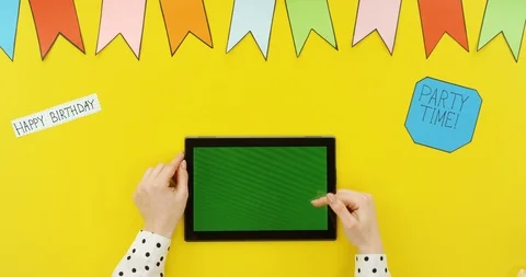 Top view on the black horizontal tablet on the yellow table with decorations Video stock 89333024