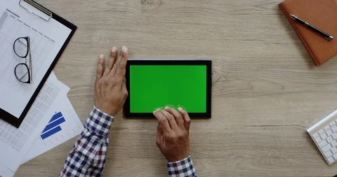 Top view on the black horizontal tablet device on the wooden light desk and Stock Footage 96016360