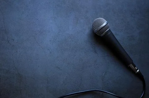 Top view of black microphone on dark background and empty space for text. Stock Photos