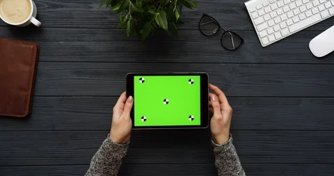 Top view on the black office desk and black tablet computer with green screen Stock Footage 85977040