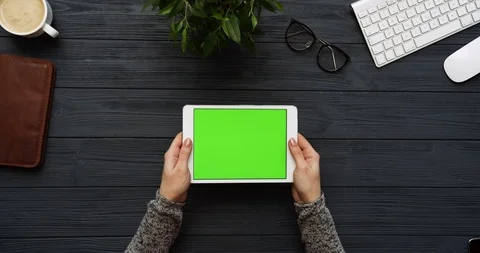 Top view on the black office desk and white tablet computer with green screen Stock Footage 85977683