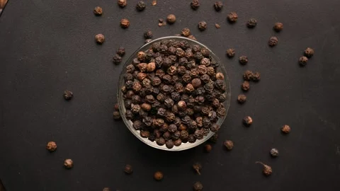 Top View of Black Pepper Seeds (Kali Mirchi) in Bowl on Black Background Stock Footage 329347356