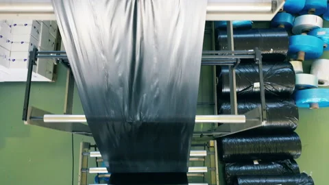 Top view of a black plastic bag production line at a polyethylene production Stock Footage 143022802