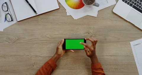 Top view of the black smartphone lying horizontally on the wooden office table Stock Footage 96000646