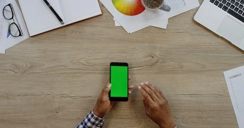 Top view of the black smartphone lying vertically on the wooden office table Video stock 96004047