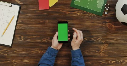 Top view on the black smartphone lying vertically on the wooden table with Stock Footage 96315072