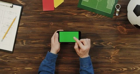 Top view on the black smartphone lying horizontally on the wooden table with Stock Footage 96315409