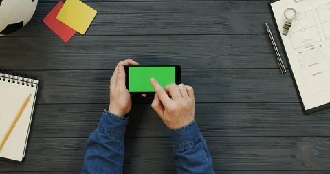 Top view on the black smartphone lying horizontally on the dark grey wooden Stock Footage 96329628