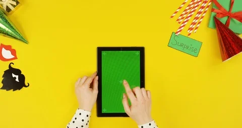 Top view on the black tablet computer on the yellow table with birthday party Video stock 89320413