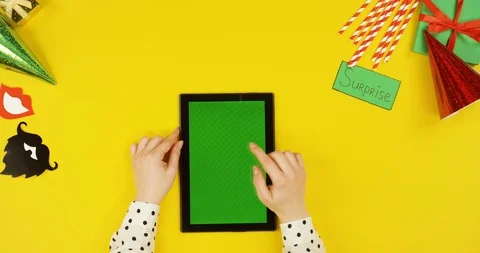 Top view on the black tablet computer on the yellow table with birthday party Stock Footage 89320950