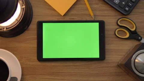 Top view of the black tablet computer lying horizontally on the wooden table. Ta Stock Footage 142217073