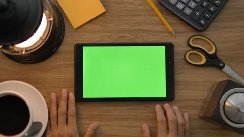Top view of the black tablet computer lying horizontally on the wooden table. Ta Stock Footage 143399112