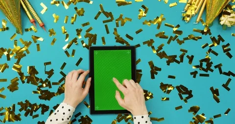Top view on the black tablet device with green screen lying on the blue table Stock Footage 89308413