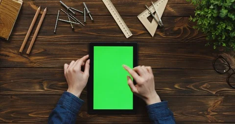 Top view on the black tablet device lying vertically on the wooden table with Stock-Footage 96175660